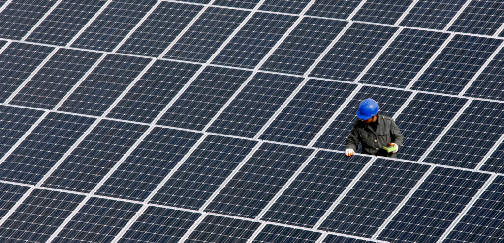 A man repairs solar panels