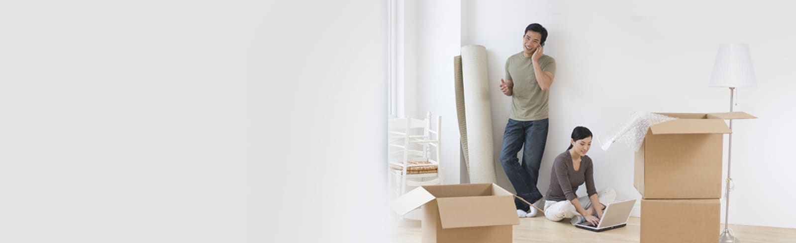 hands holding a piggy bank and a house paper cut silhouette