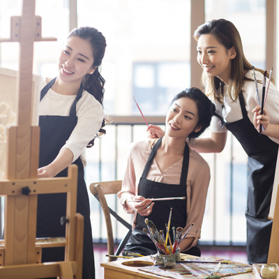 Young women painting in studio