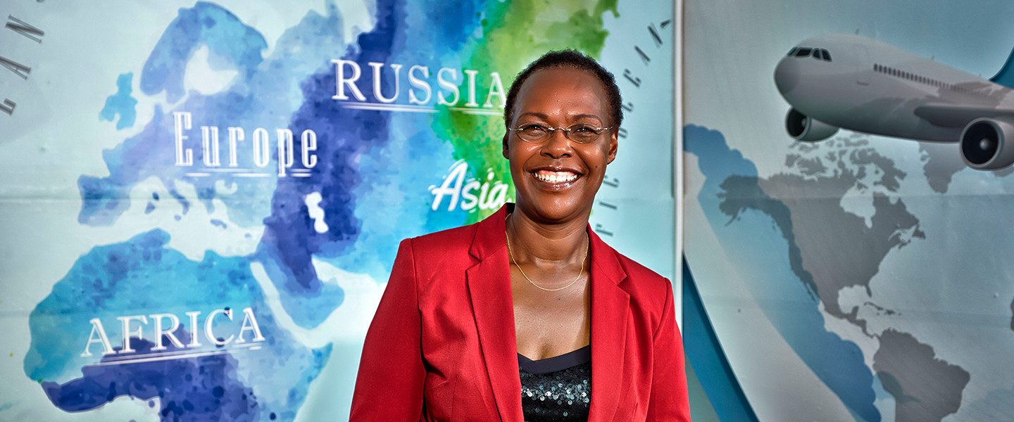 woman standing in front of world map