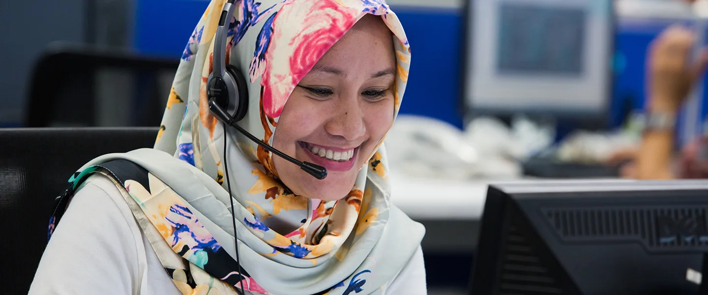 woman set at computer using headset