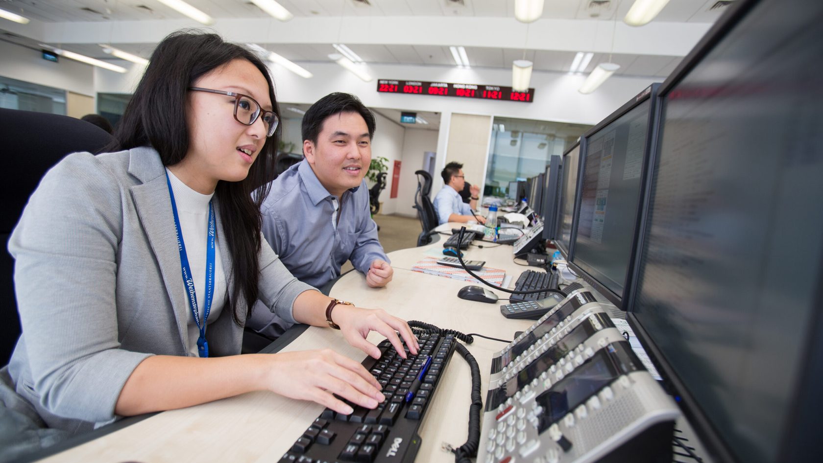 2 people working together at computer
