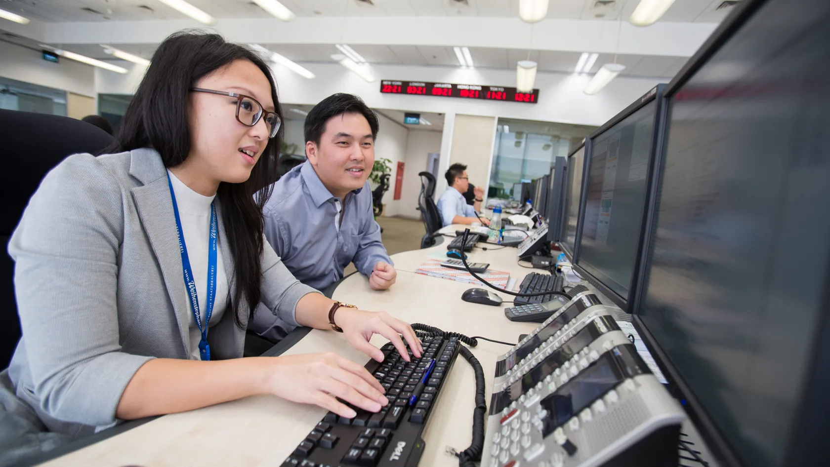 2 people working together at computer
