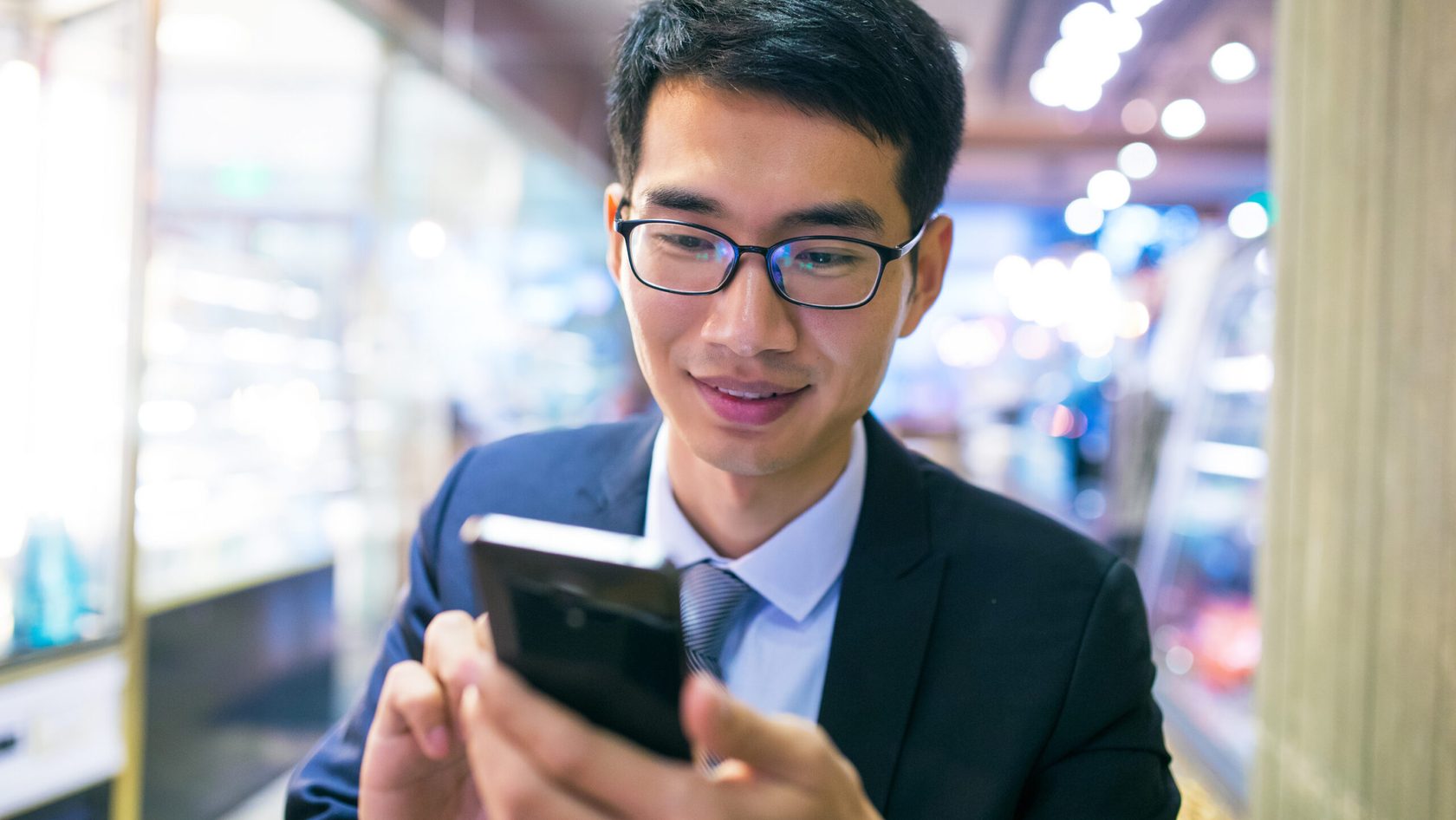 man using phone indoors