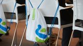 A Standard Chartered bag on a chair