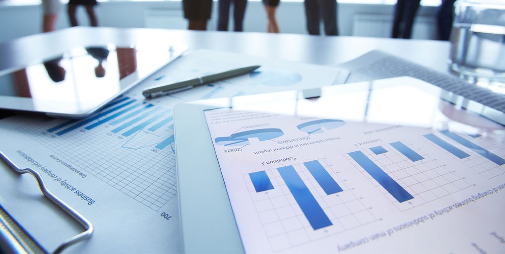 Business materials showing graphs and charts on device