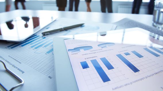 Business materials showing graphs and charts on device