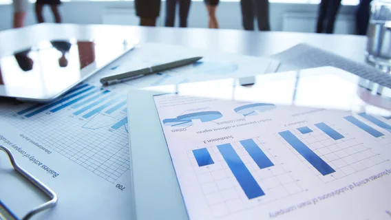 Business materials showing graphs and charts on device