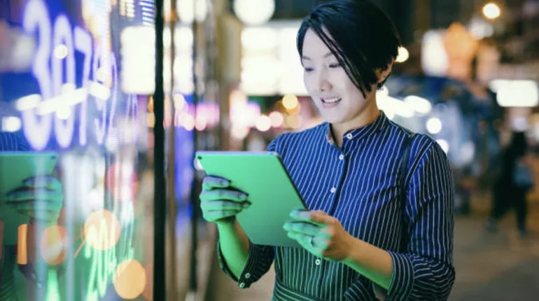 Businesswoman checking stock market data on tablet