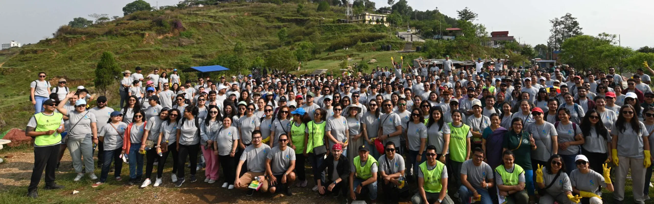 A group of Standard Chartered employees pose together on an outdoor volunteering opportunity.