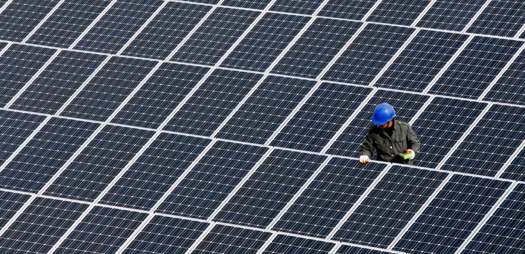 A man repairs solar panels