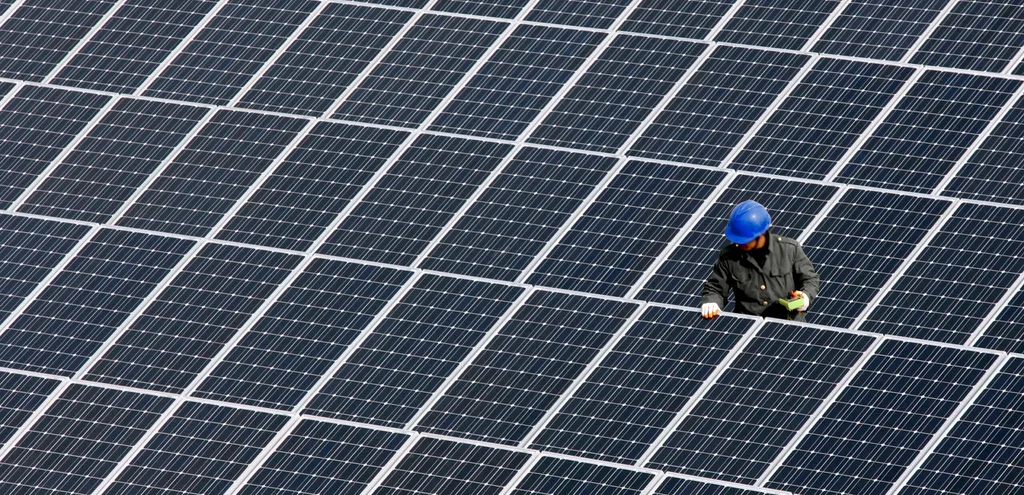 A man repairs solar panels