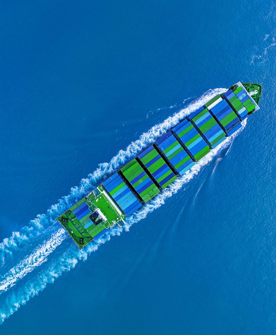 A ship transporting blue and green containers.