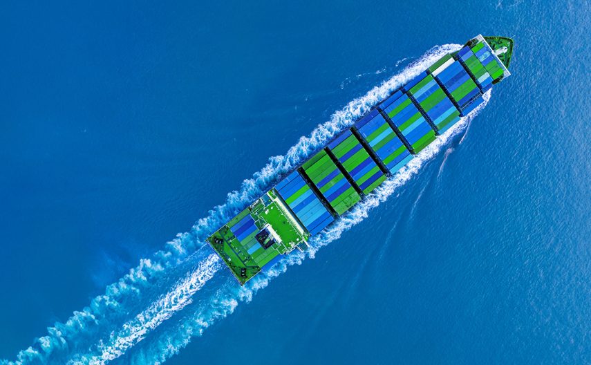 A ship transporting blue and green containers.
