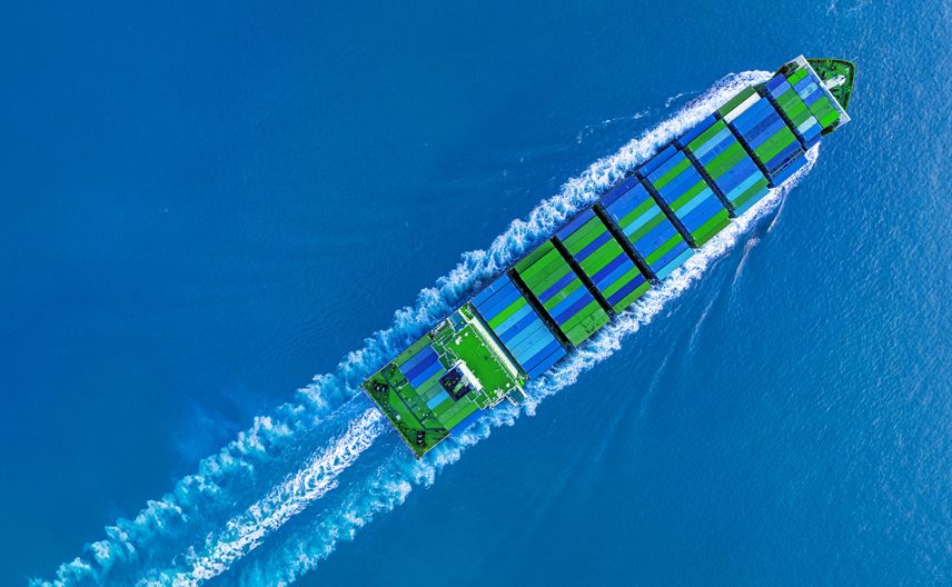 A ship transporting blue and green containers.