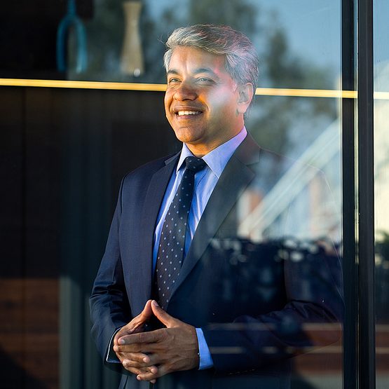 A wealthy, affluent investor smiles.