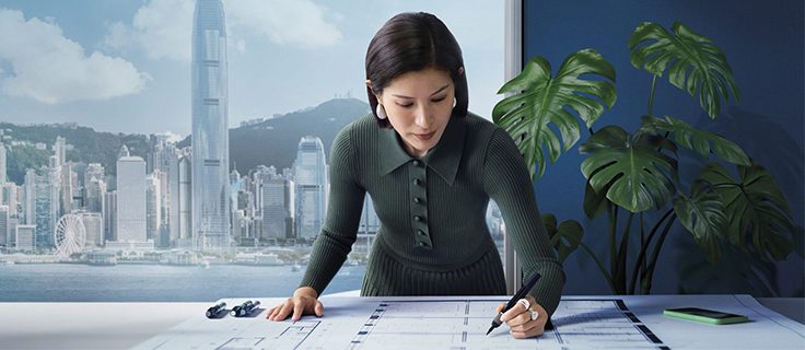A woman sketches plans for her business.