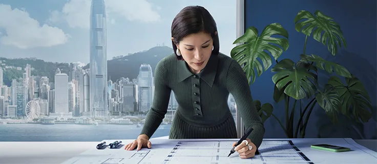 A woman sketches plans for her business.