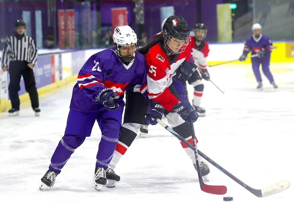 An action shot depicting Josephine Hamnett competing in the SEA Games alongside the Singapore Ice Hockey Association. An action shot depicting Josephine Hamnett competing in the SEA Games alongside the Singapore Ice Hockey Association.