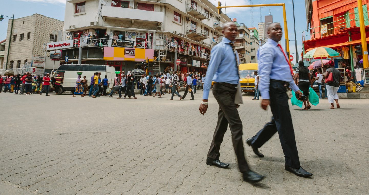 2 businessmen crossing street in city