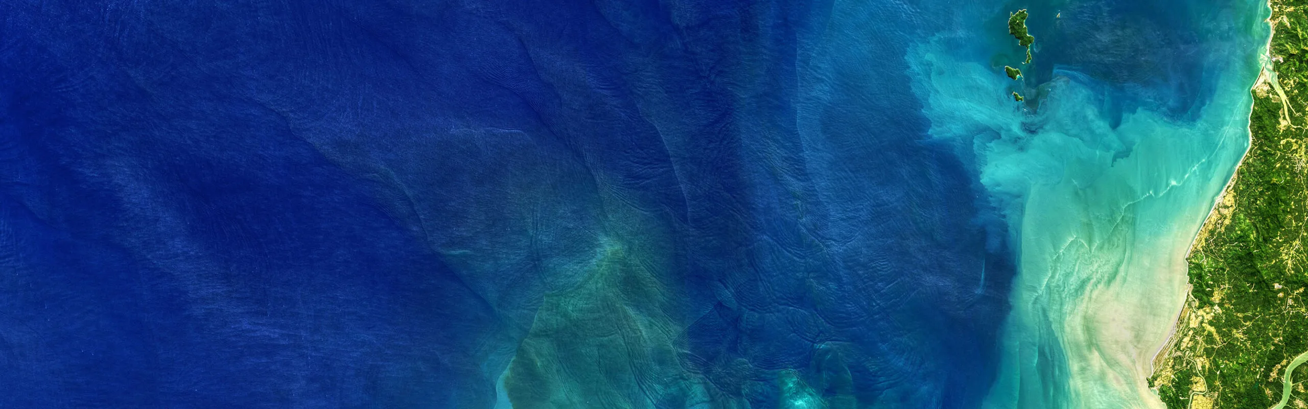 An ocean shoreline seen from above.