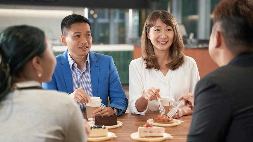 Colleagues having coffee in office
