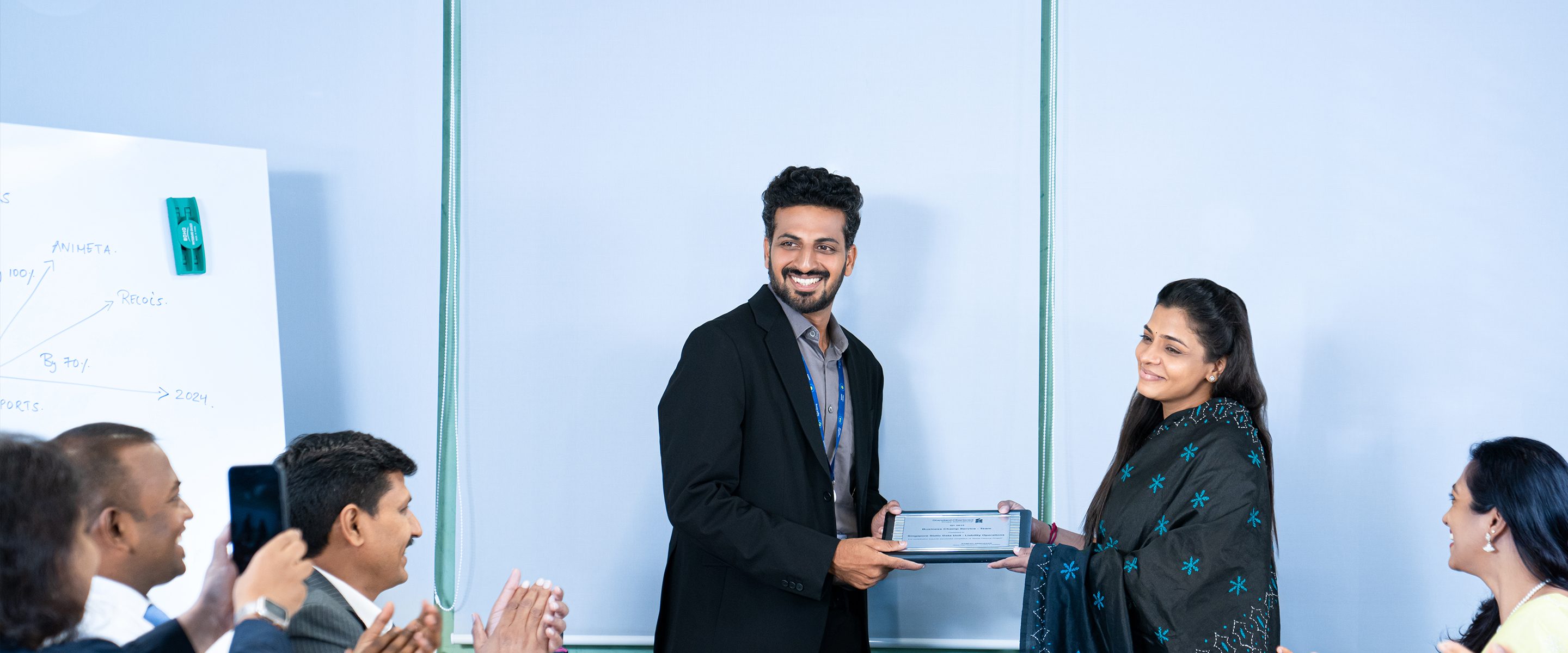 Colleagues in our Chennai office applaud as one of the team receives an award