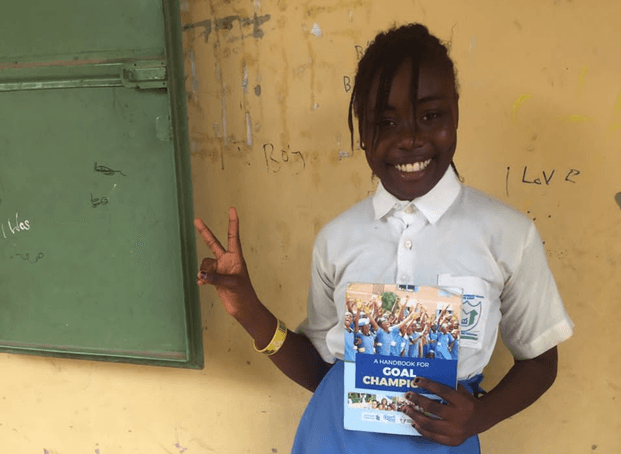 School student in uniform holding a pamphlet