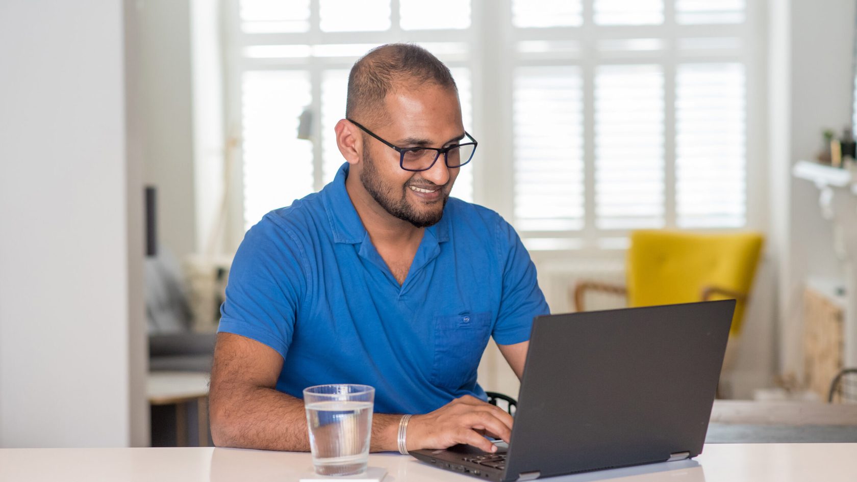 man using laptop at home