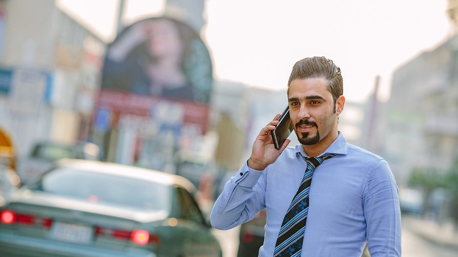 man talking on phone outside