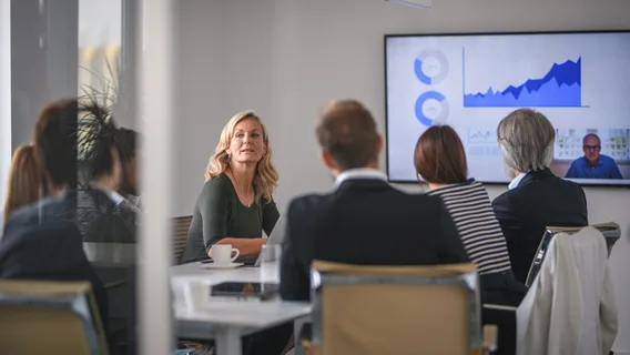 A group of diverse ethnicity people sitting at a office table having meetings