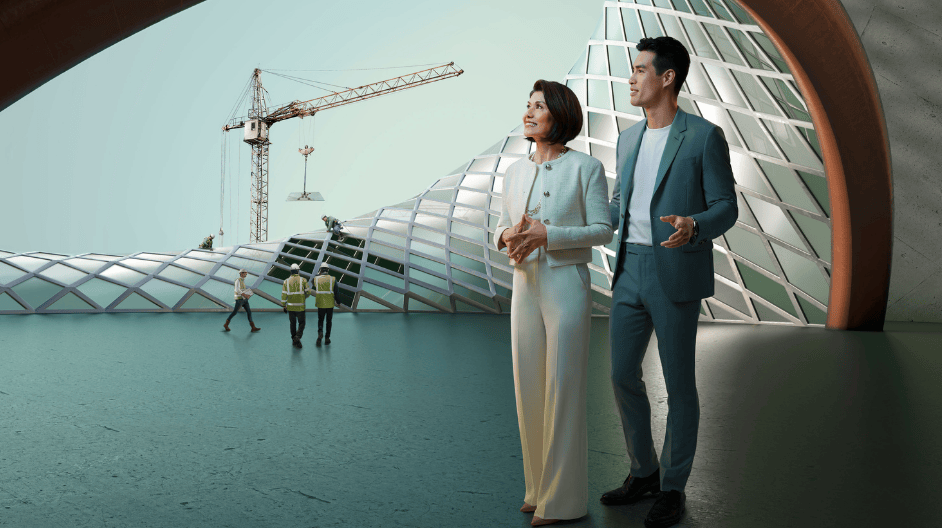 A man and woman stand together in front of a modern building