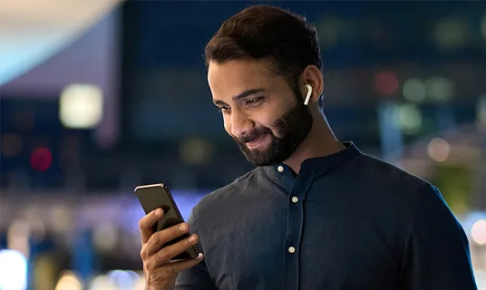 A man looks at his phone.