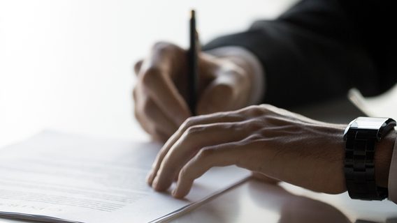 Businessman after successful negotiations signing contract document