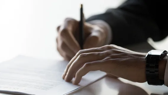Businessman after successful negotiations signing contract document