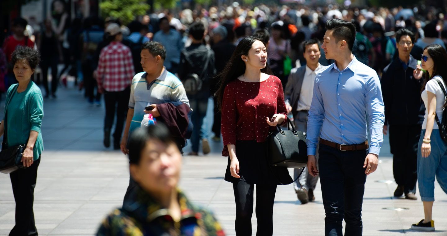 People walking through busy city centre