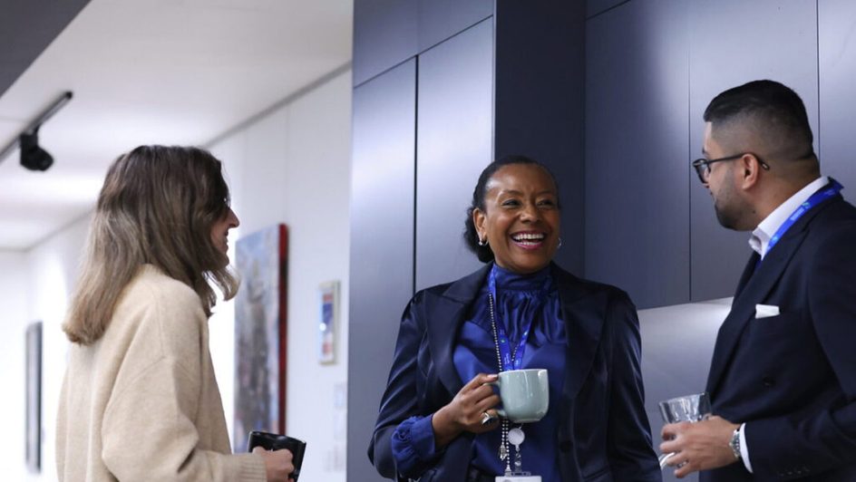 Colleagues chat in Standard Chartered's London HQ.