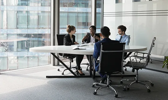 Colleagues work together in a meeting room.