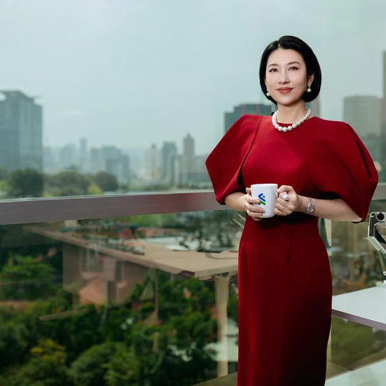 Employee with a cup in a red dress