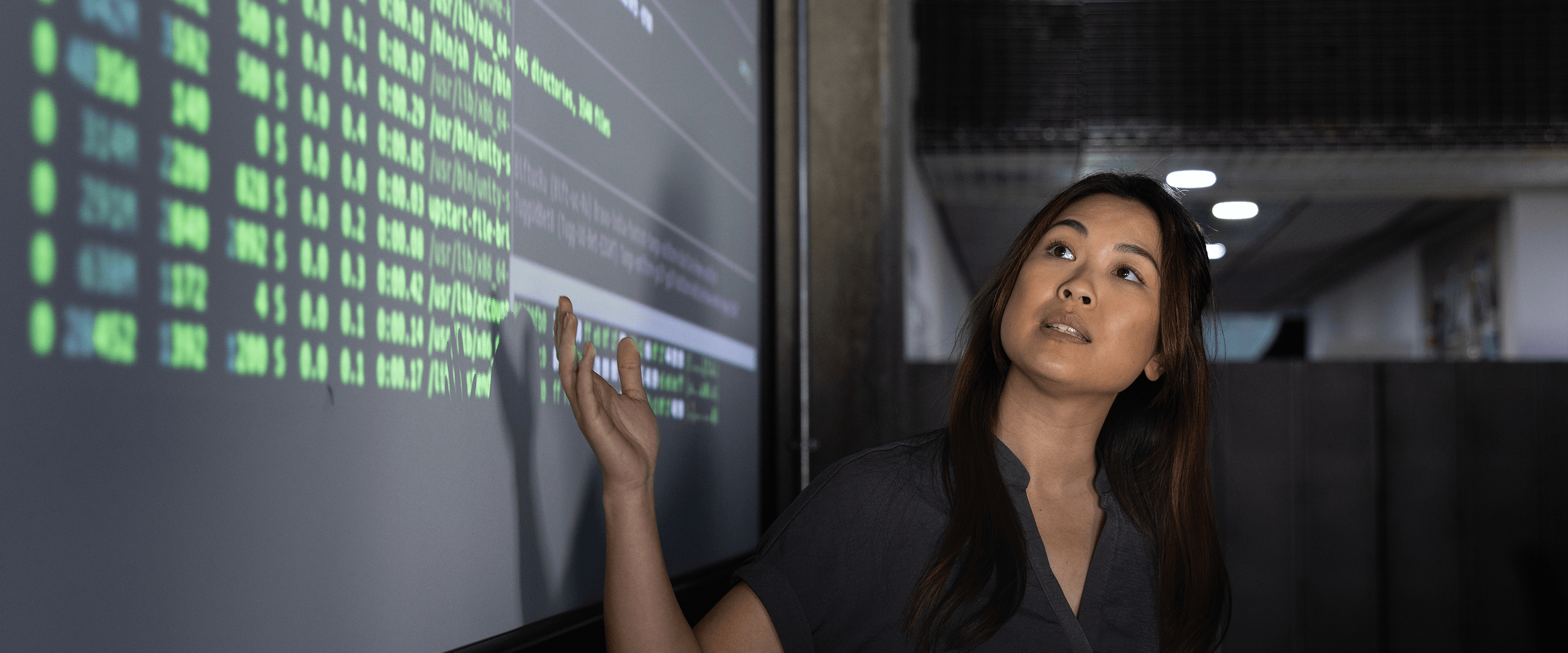 A data scientist presents information about fighting financial crime on a screen.
