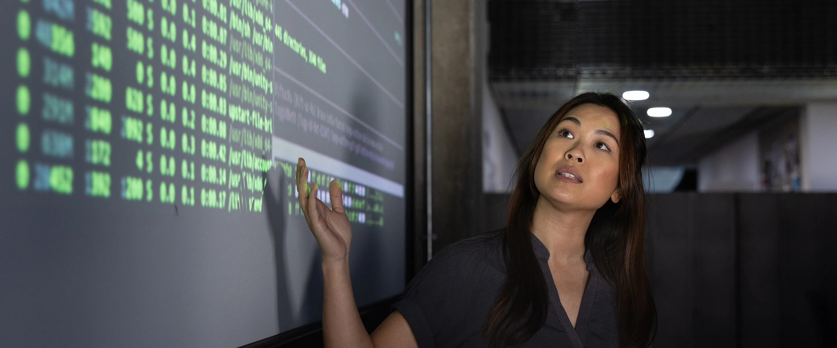A data scientist presents information about fighting financial crime on a screen.