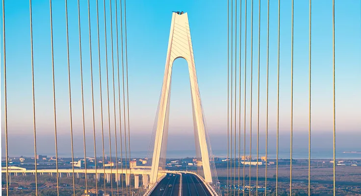A photograph of a bridge symbolises global shifts in supply chain connectivity.