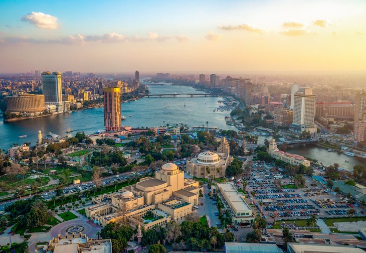Aerial view of Cairo, Egypt, featuring the Nile river running through the city.