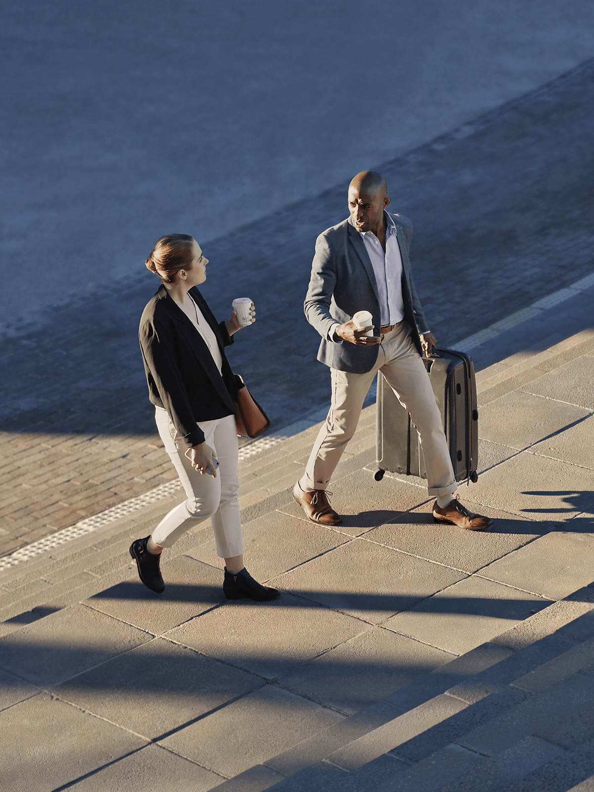 Two government staffers discuss policy while walking together.