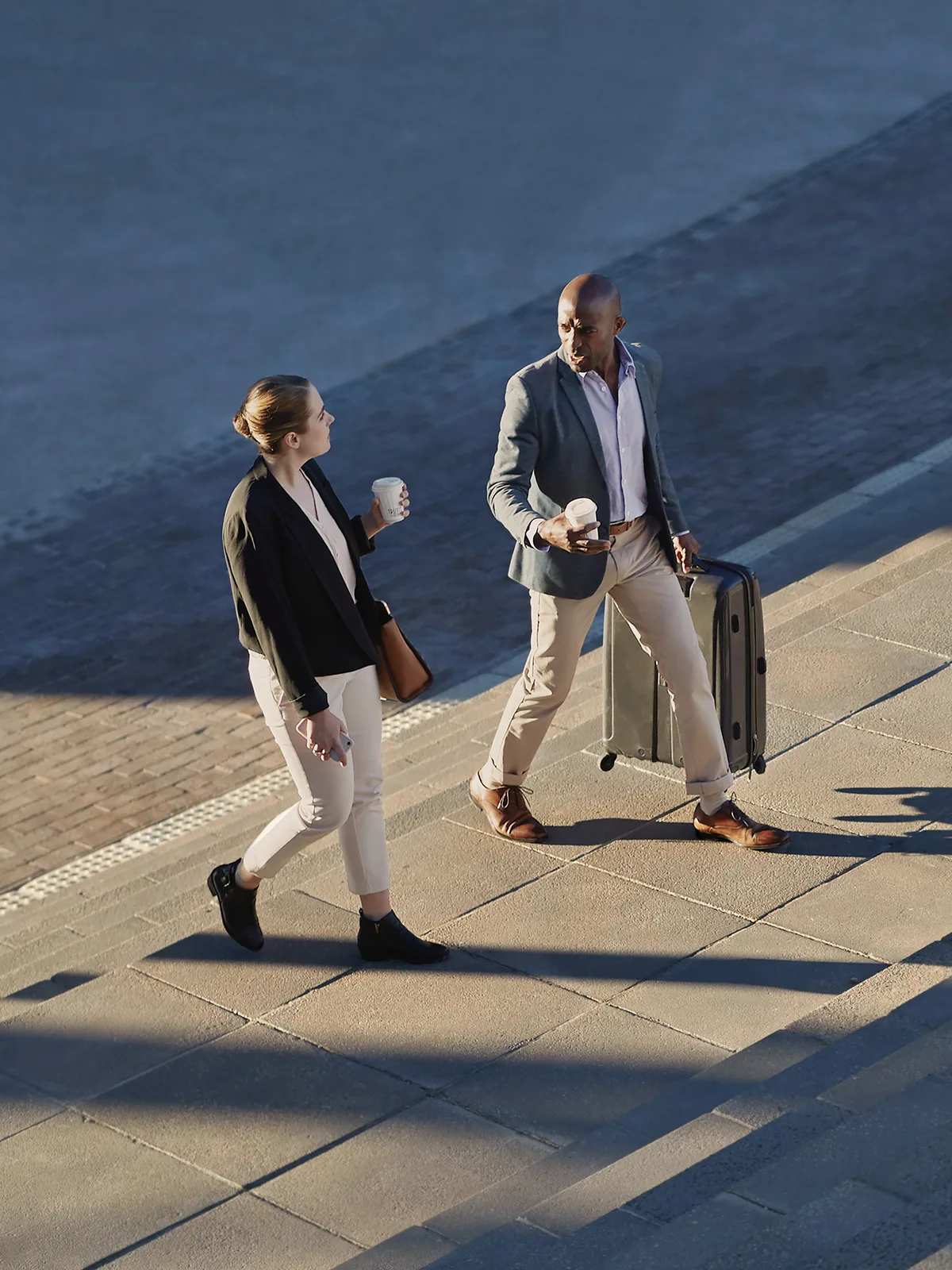 Two government staffers discuss policy while walking together.