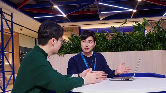 Colleagues talking round a table