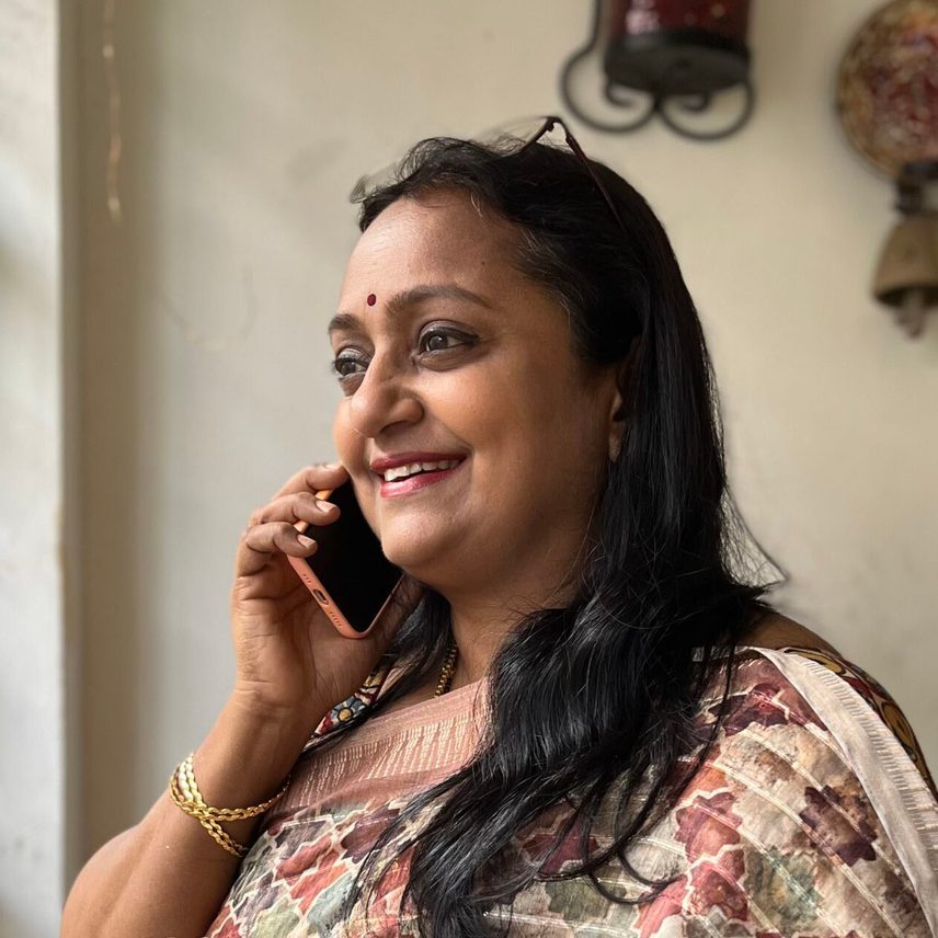 A woman in a saree, talking on the phone