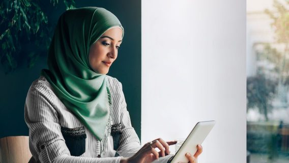 Middle East Woman with tablet on coffee table