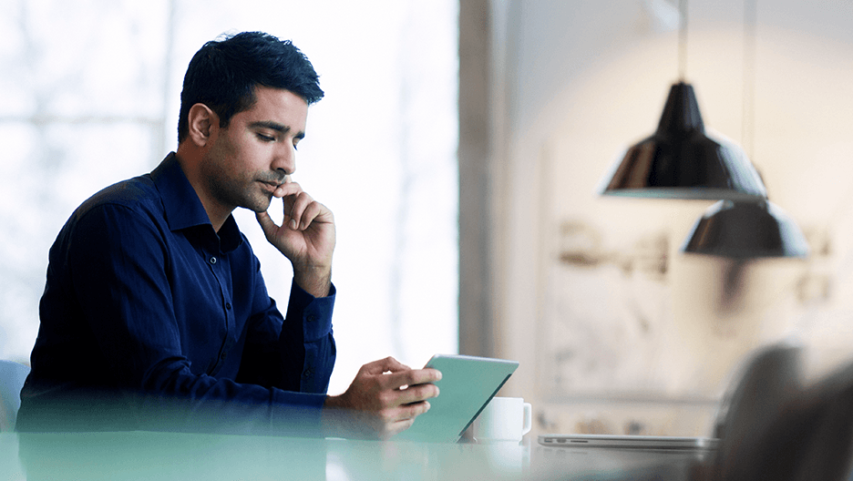 An investor reads on an iPad.