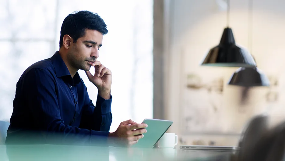 An investor reads on an iPad.